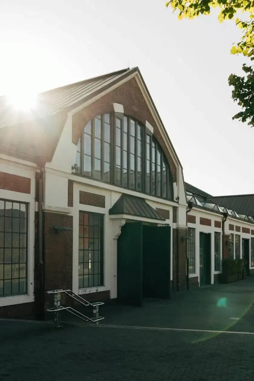 Restored Fort Worth commercial building with arched windows and green entry doors