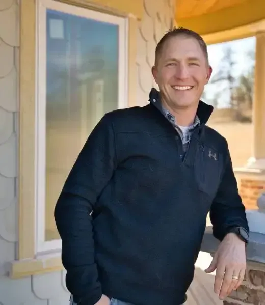 Covenant Construction founder on a North Texas home’s front porch